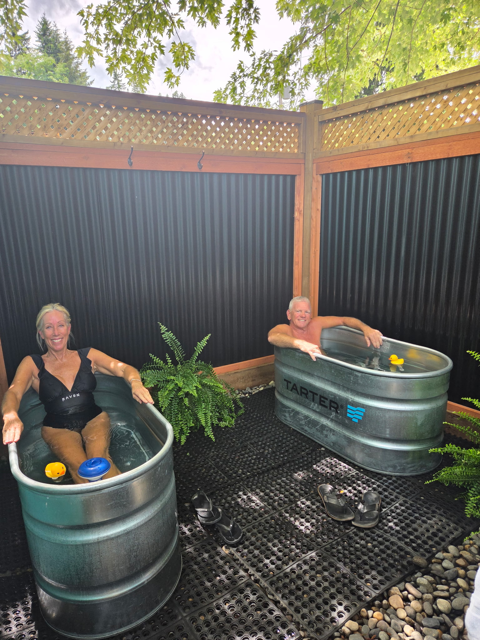Two guests enjoying the outdoor cold plunge tubs at Contrast by Raven